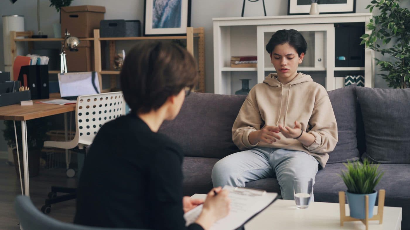 Teenager in conversation with therapist
